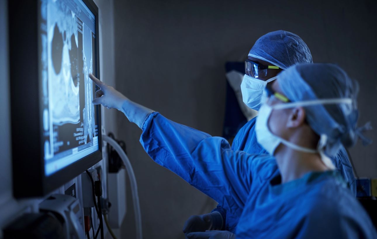 Surgeons looking at monitor